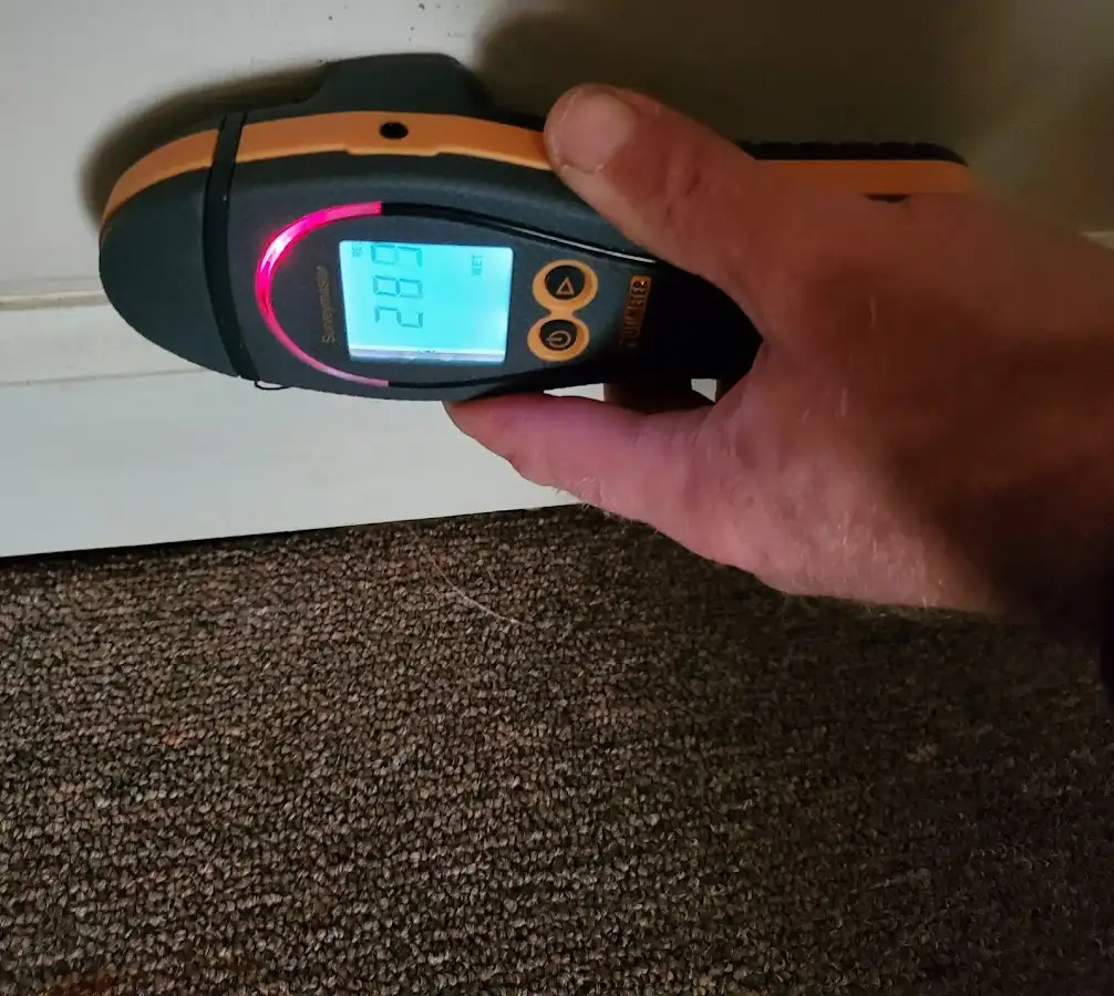 Moisture detection at baseboard during Storm Damage Restoration in Ione